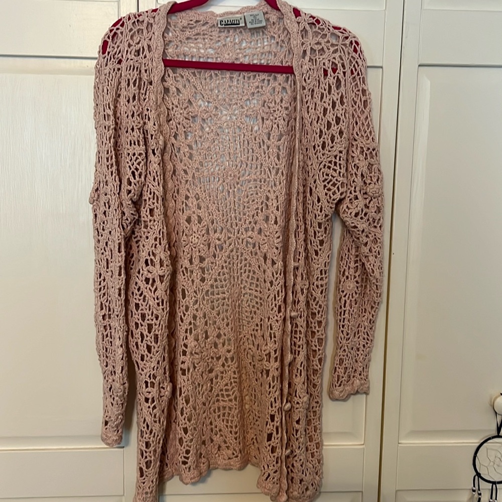 Pink crocheted sweater in size small.